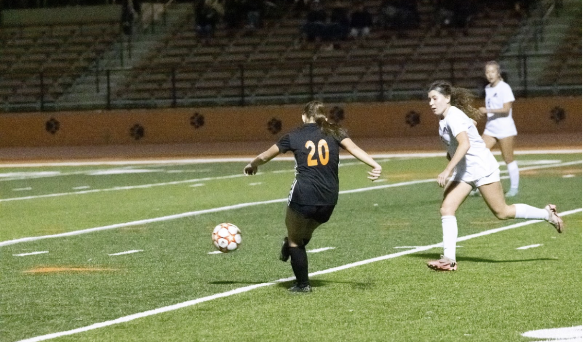 The girls varsity soccer team passes up the field to help lead the team to a goal.
